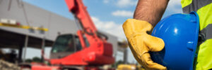 Construction worker holding hard helmet