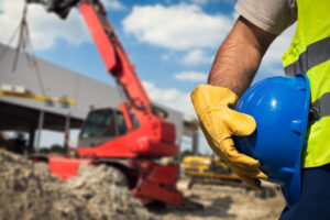 Construction worker holding hard helmet